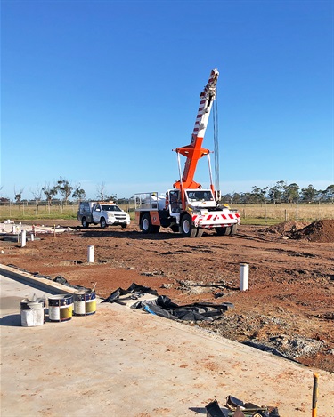 Trucks and machinery have arrived on site with the steel framing materials.