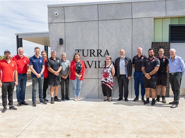 Club members and funding partners in front of the new pavilion