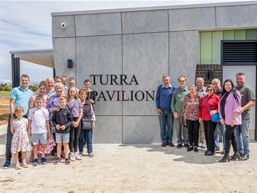 Club members and funding partners in front of the new pavilion