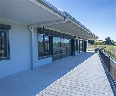 The external viewing area, complete with sliding doors, composite decking, safety rails and protective roller shutters.